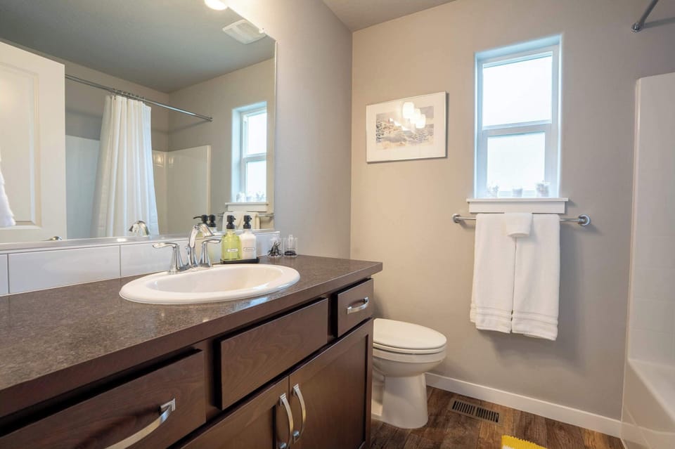 Clean and simple shared bathroom stocked with essentials for your stay.