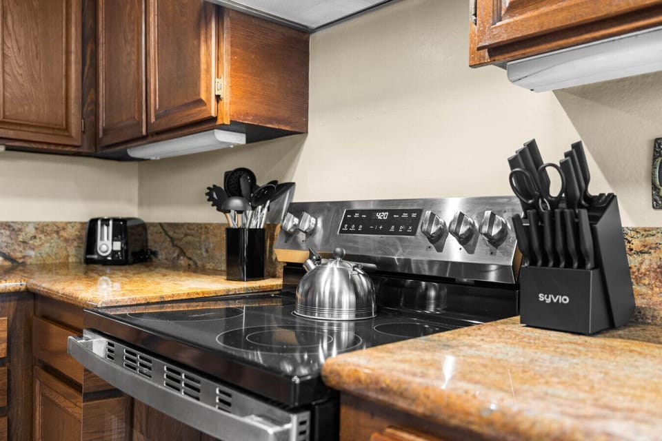 Enjoy a functional kitchen setup complete with essential cookware, expansive counters, and everything needed for home-cooked meals.