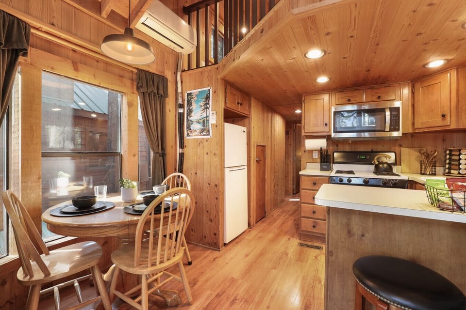 Enjoy meals, morning coffee, or a glass of wine at the cozy dining table for three, or pull up a barstool at the kitchen counter—perfect for casual bites and conversation.