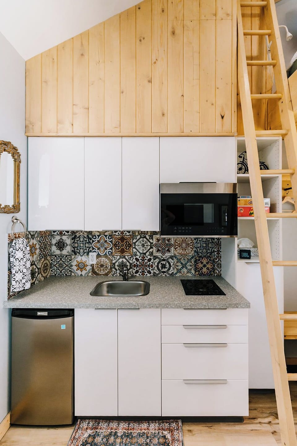 Kitchen space - microwave, induction stove top, sink, mini fridge