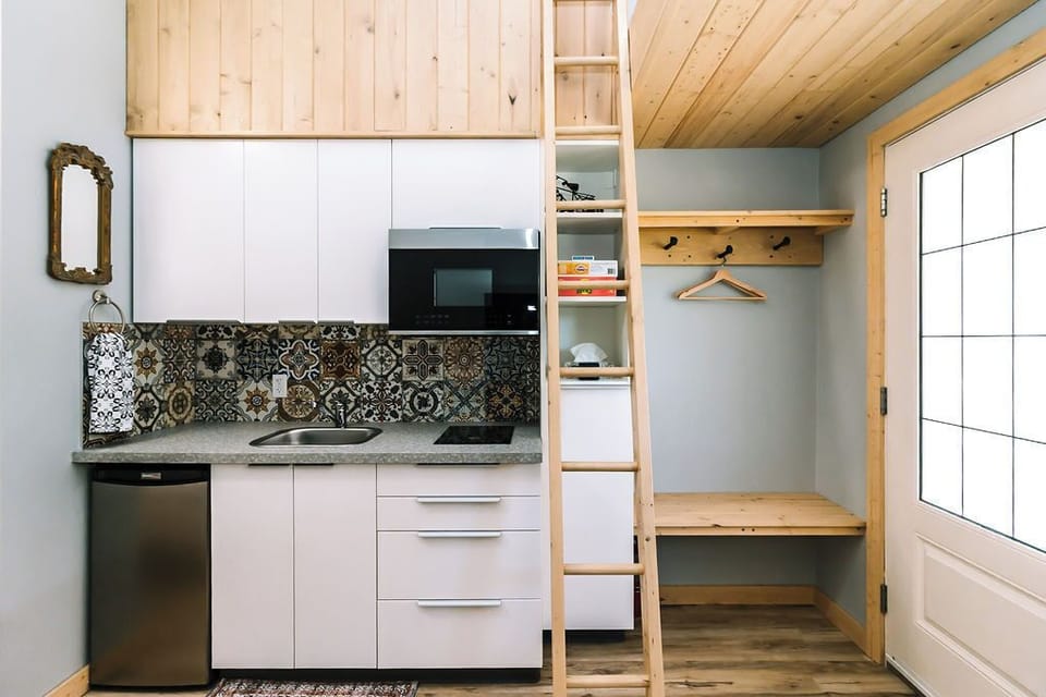 Front entrance, ladder to loft area and kitchen space