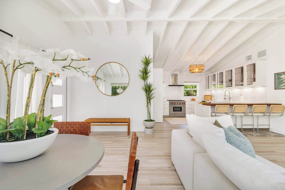 Bright open-concept living area with a modern kitchen and breakfast bar seating.