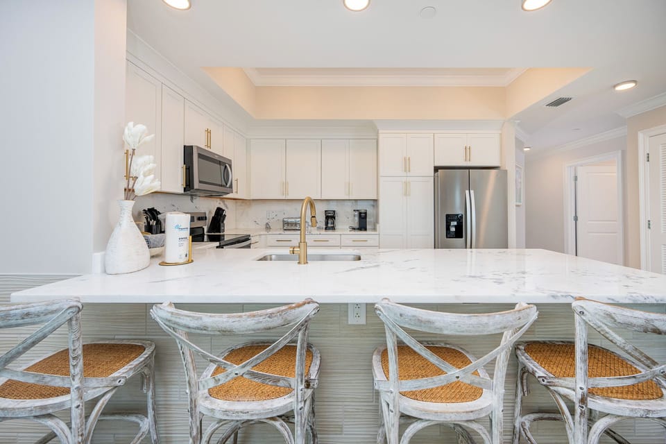 Gather around the elegant breakfast bar with stylish seating, perfect for morning coffee and conversations