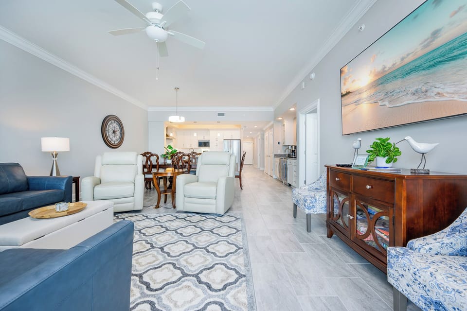Relax in the spacious living area with comfortable seating, stylish decor, and coastal vibe
