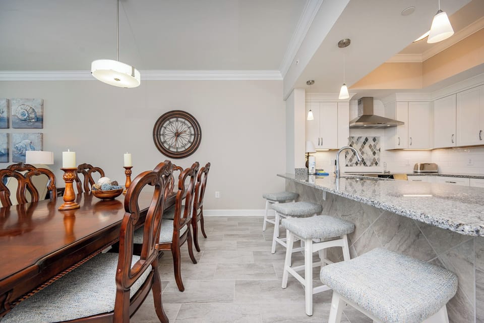 Gather around the elegant dining table or enjoy casual meals at the stylish bar with comfortable seating