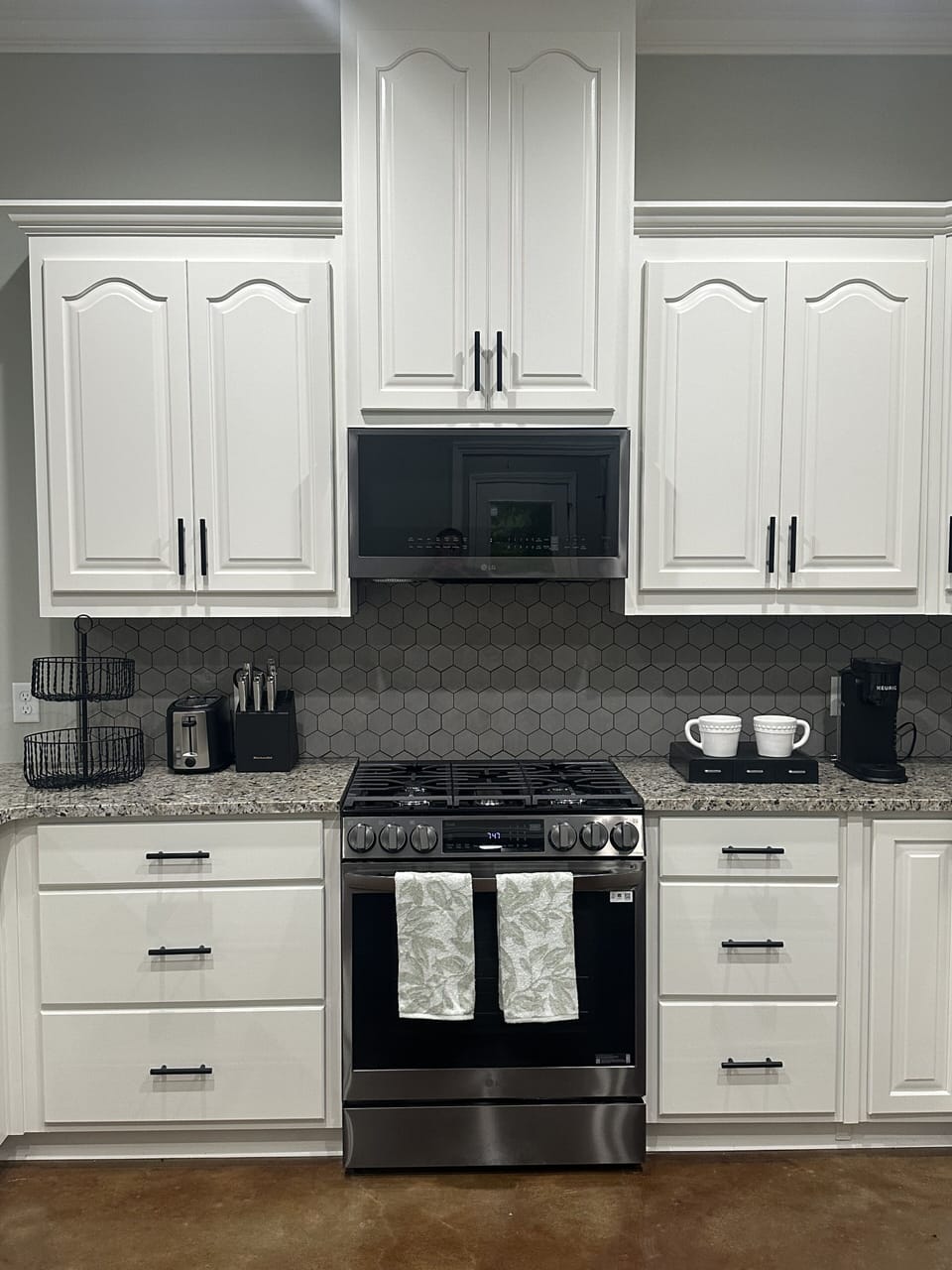 High ceilings, modern cabinets, and granite countertops for luxurious details.