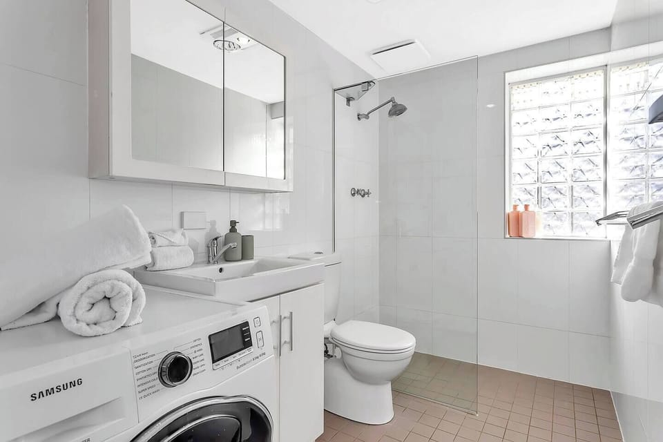 Refresh in the family bathroom with a walk-in shower, while a nearby washer adds convenience for longer stays.