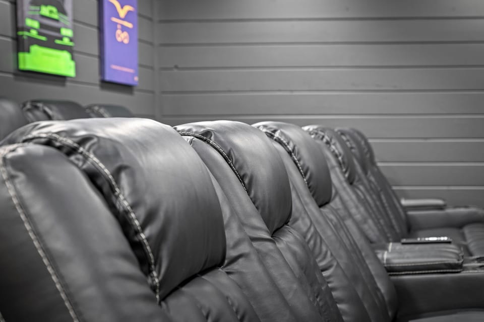 Private theater room with reclining seating and a large screen for movie nights in.