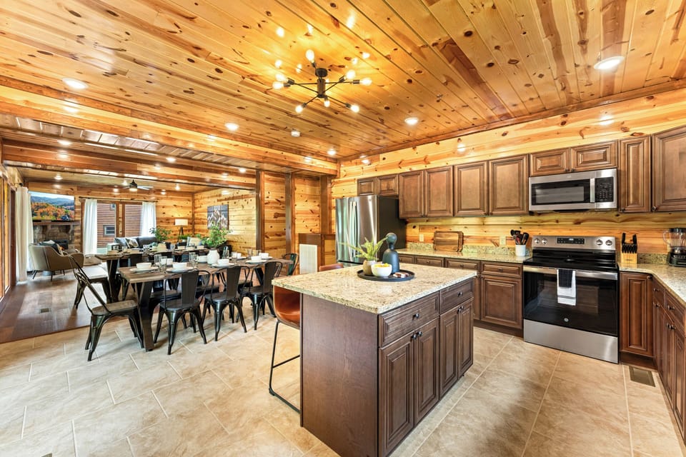 Fully equipped chef’s kitchen with granite countertops and bar seating.