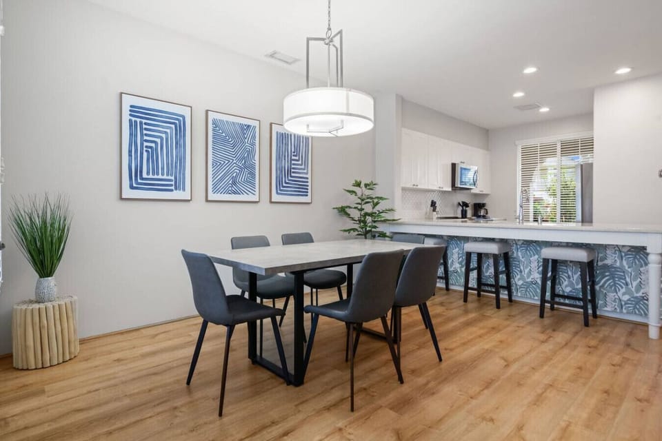Stylish dining area with modern décor and seating for six—perfect for shared meals and gathering with friends or family.