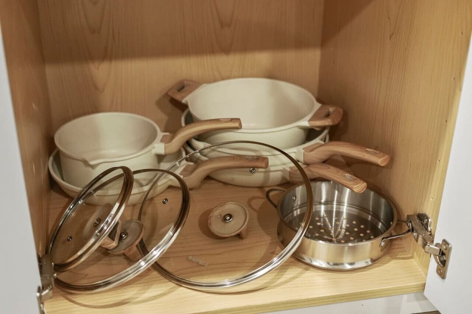 Kitchen cabinets stocked with cooking wares, glassware and silverwares, ideal for mixing up your favorite meals and drinks during your stay.