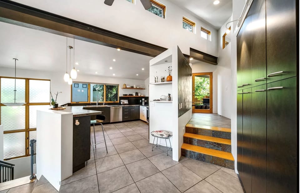 A space defined by contrast, blending organic calm with a sleek industrial edge.