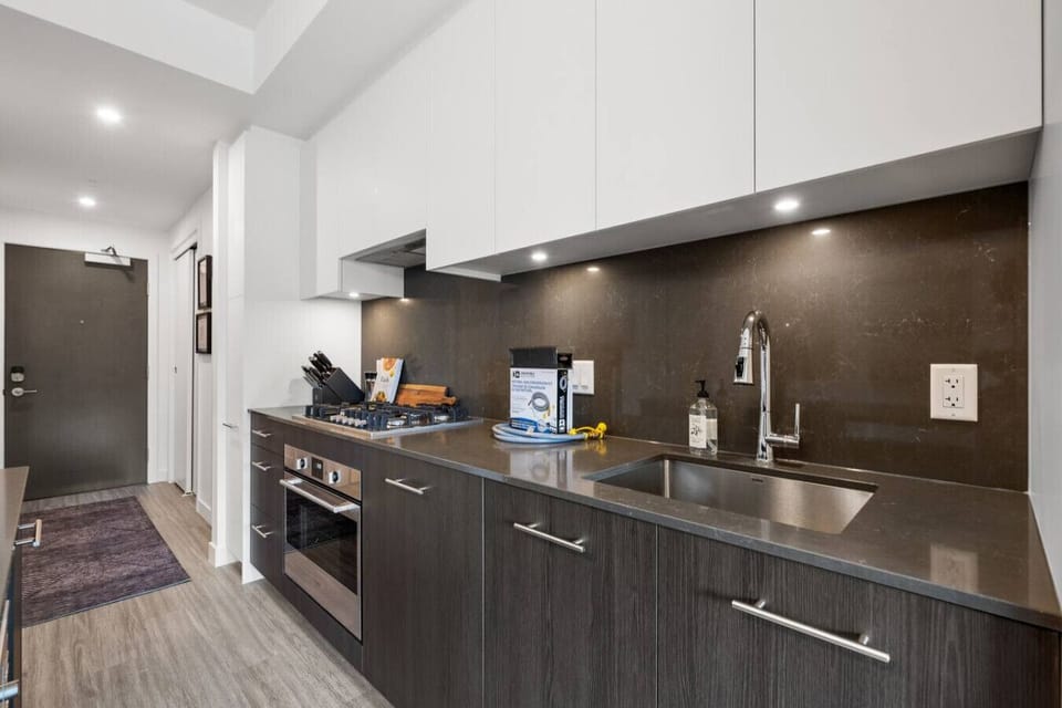 Full kitchen with a drip coffee maker, ground coffee, tea & sugar.