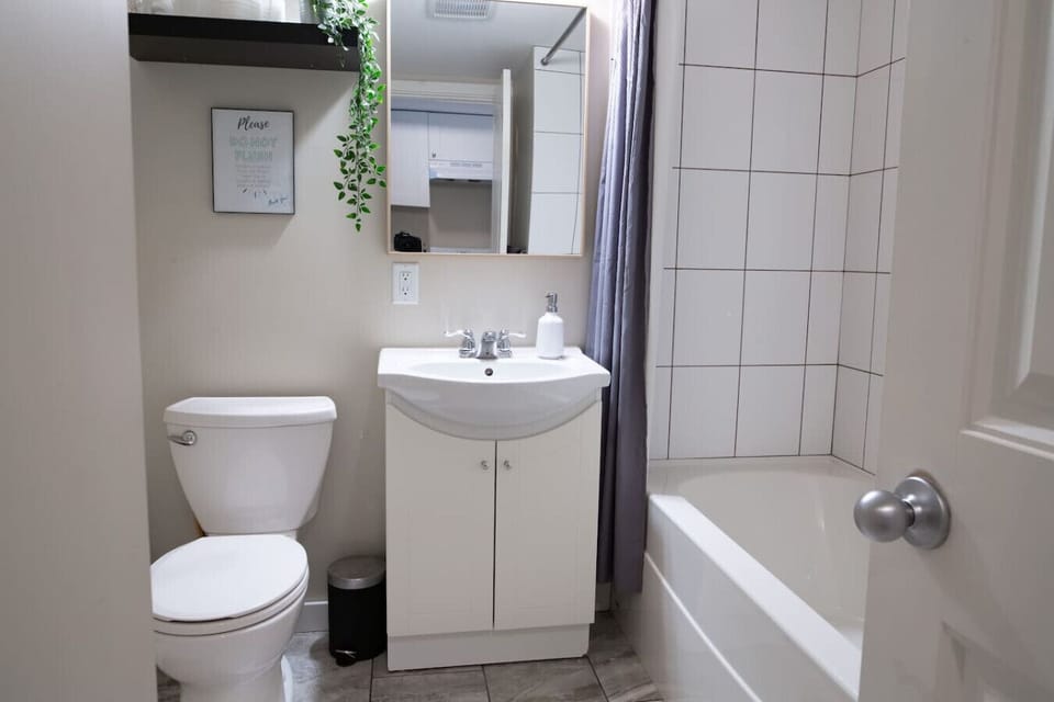 Full bathroom with bathtub, shower and fresh towels.
