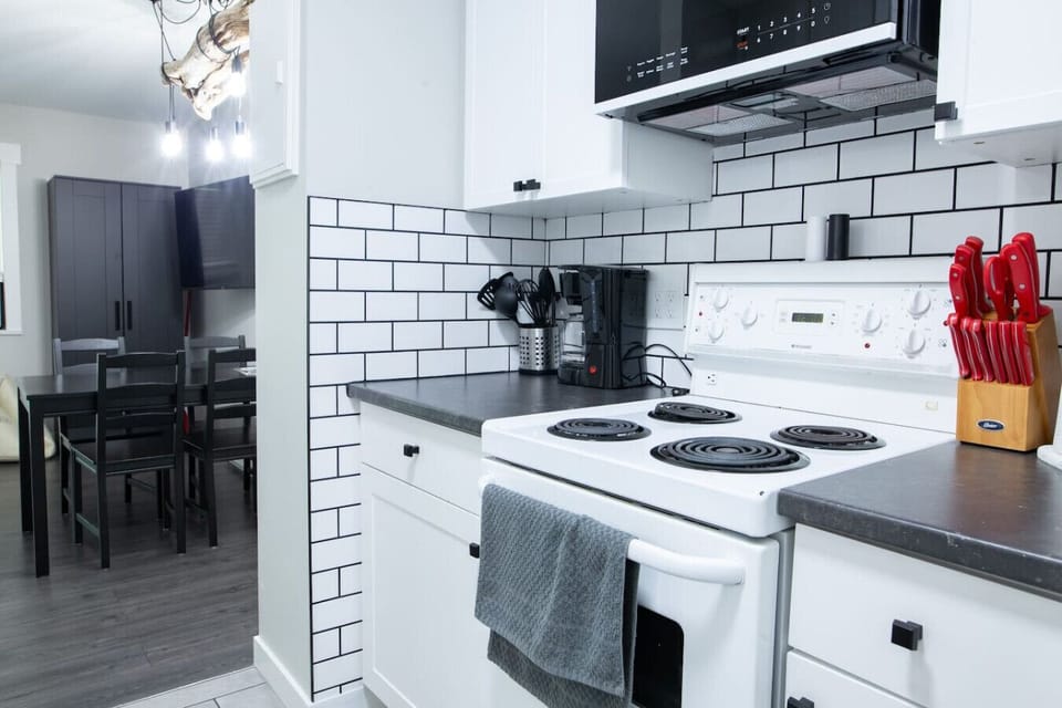 Fully equipped kitchen leads into the main area.