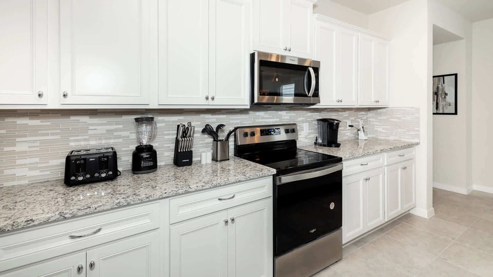 The open kitchen is bright & fully equipped for your visit