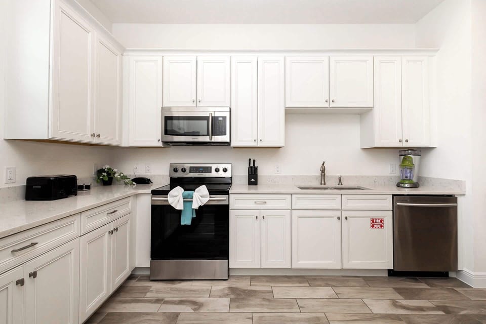 The bright, open kitchen offers ample space & all the comforts of home