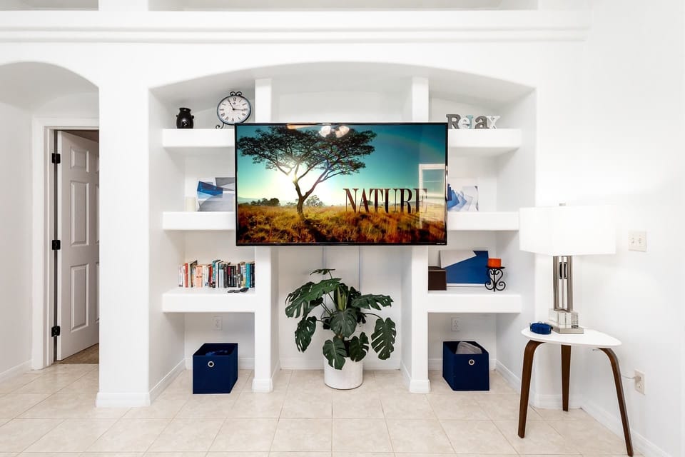 Back living area with queen sofa sleeper, Smart TV, and patio access