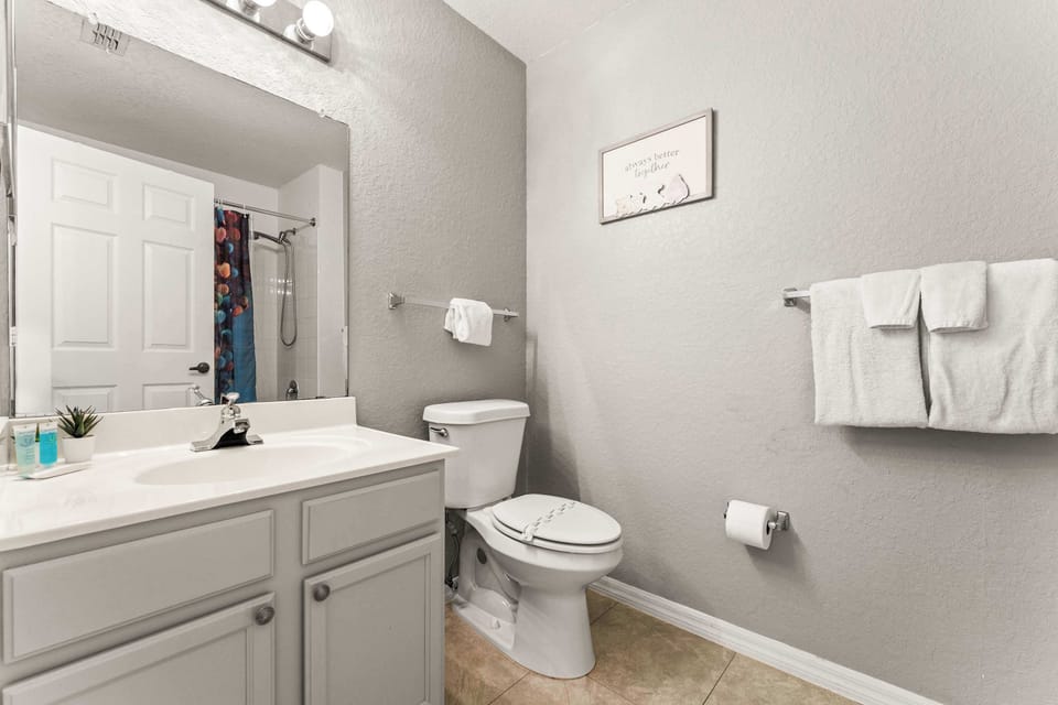Shared bathroom w/ shower/tub combo & an additional separate vanity area