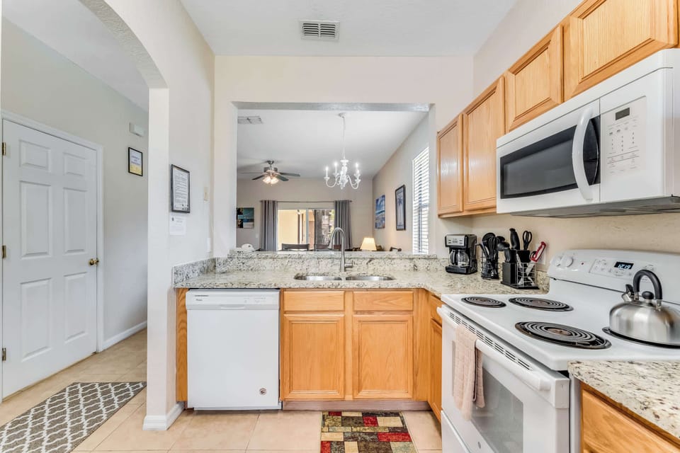 The streamlined kitchen offers ample storage space and wonderful amenities