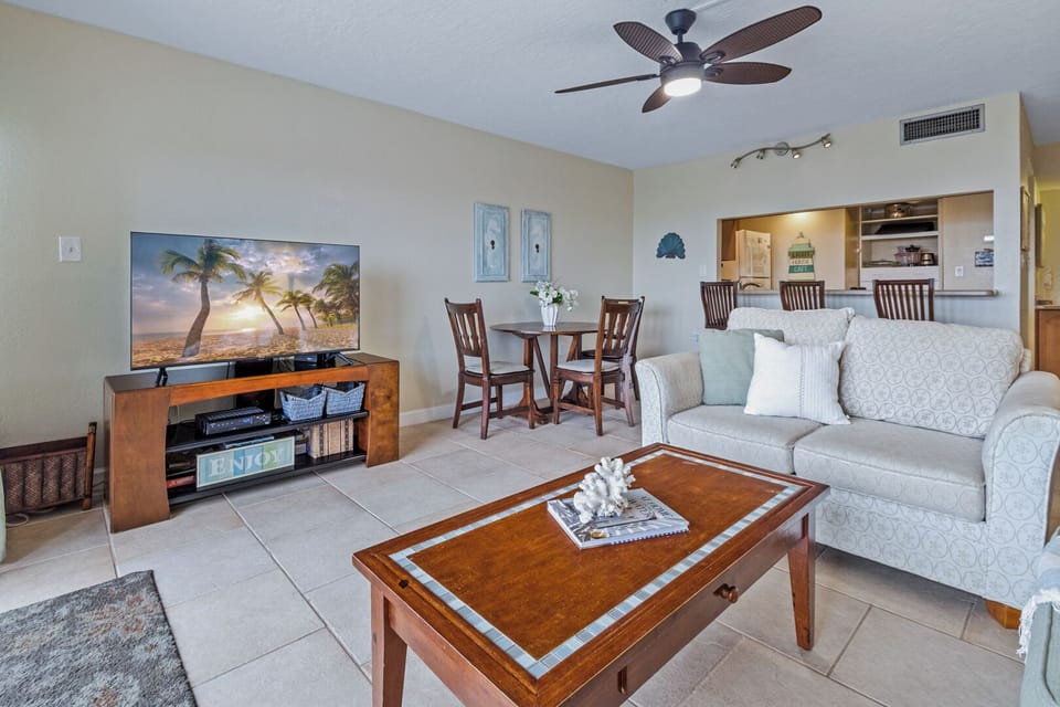 Coastal-style living area with TV and comfy seating, ideal for relaxing after beach adventures.