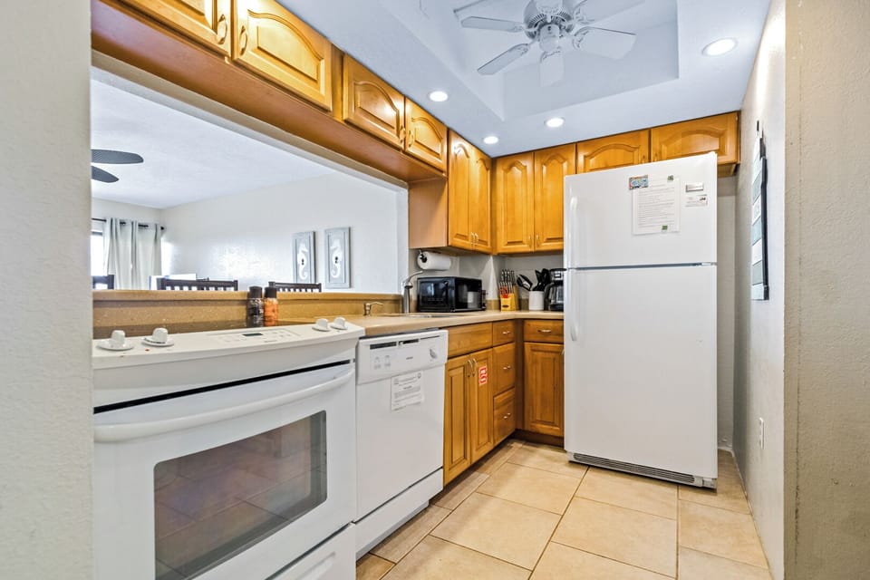 Cook with ease in this complete kitchen stocked with essentials and surrounded by beachy charm.