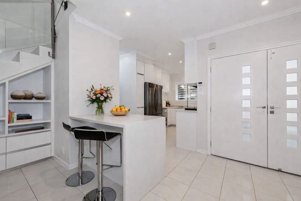 Fully equipped modern kitchen with breakfast bar and stainless steel appliances