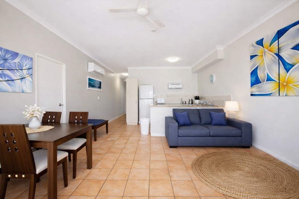 Bright and airy open-plan living space featuring a modern kitchen, comfortable lounge, and dining area with relaxed coastal styling.