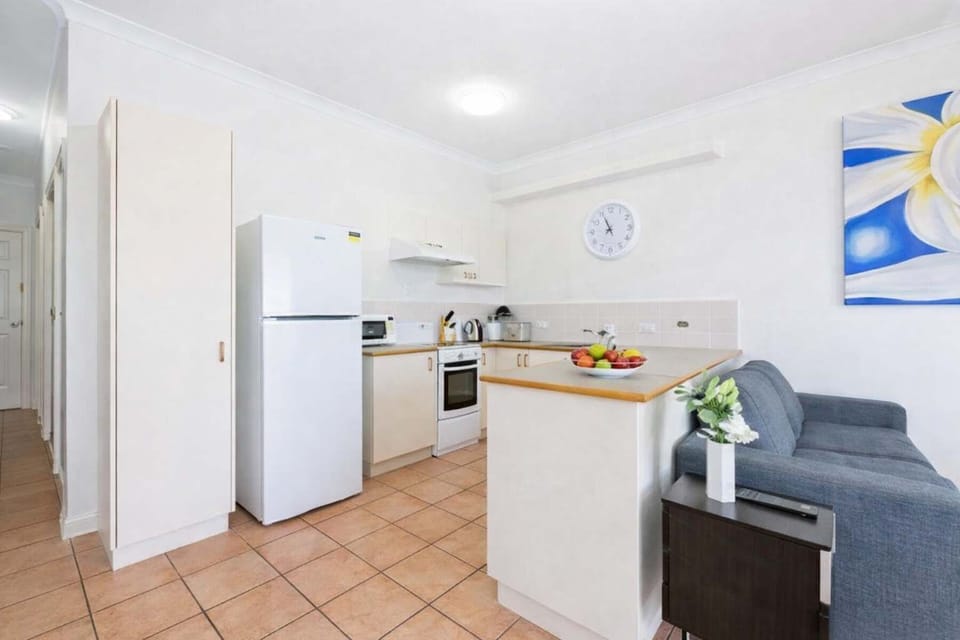 Modern, well-equipped kitchen seamlessly connected to a comfortable lounge for easy, relaxed living.