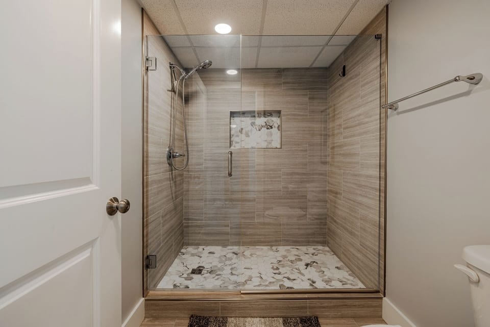 Large walk in tiled shower in the guest bath