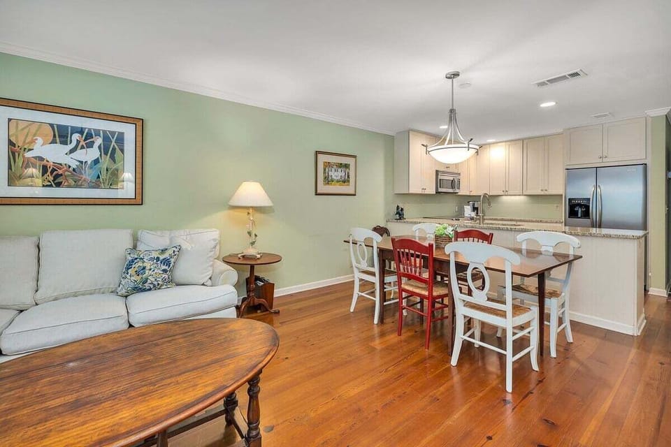 Open living and dining area with hardwood floors
