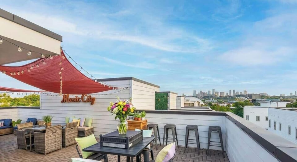 Discover your Downtown Nashville oasis! This stunning rooftop deck offers cozy seating, vibrant blooms, and breathtaking skyline views—perfect for stylish evenings with friends or a chic bachelorette party!