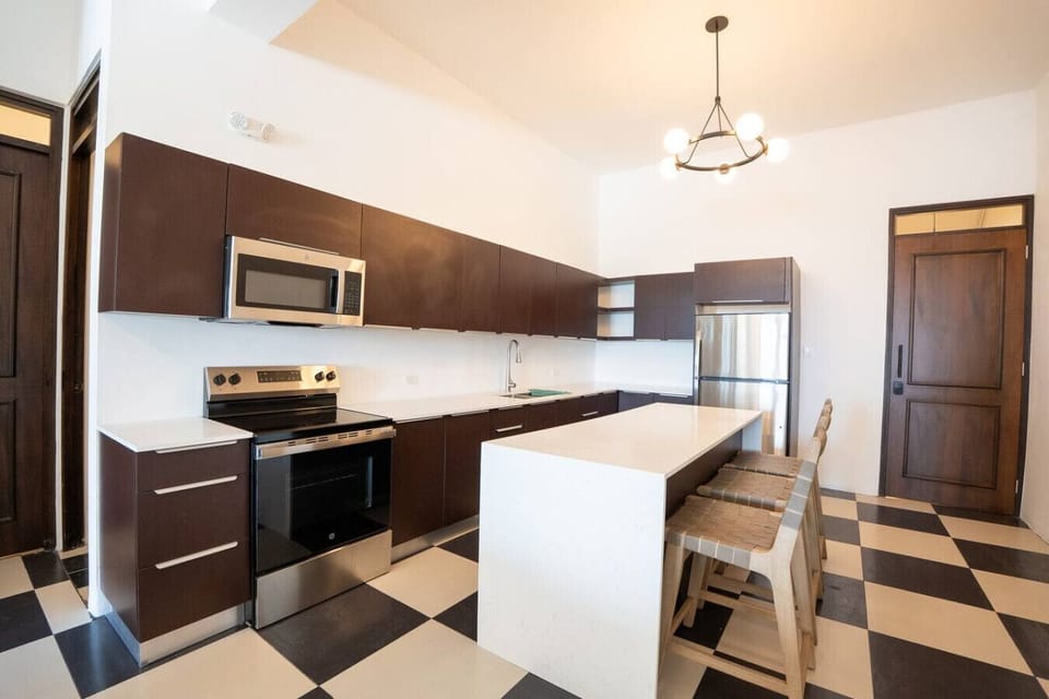 Fully equipped kitchen with modern appliances and central island.