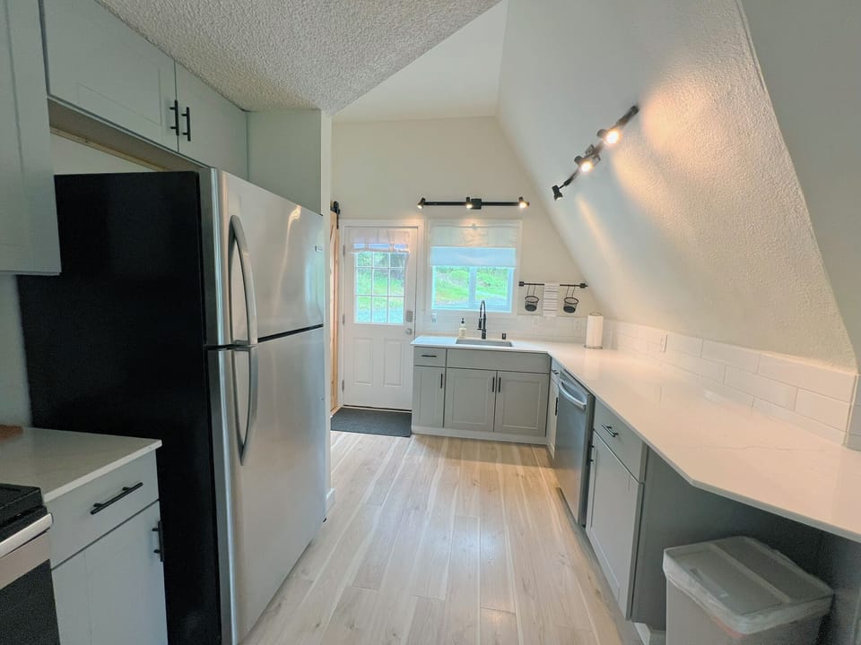 Soft, ambient lighting highlights the modern cabinetry and clean lines of the kitchen, creating an inviting atmosphere that’s perfect for family meals and entertaining.