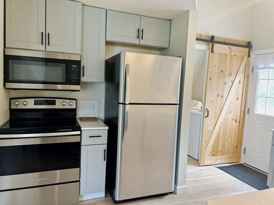 Fully Equipped Kitchen — Featuring sleek stainless steel appliances, this kitchen makes meal prep a breeze—whether you're whipping up a quick breakfast or crafting a gourmet dinner.