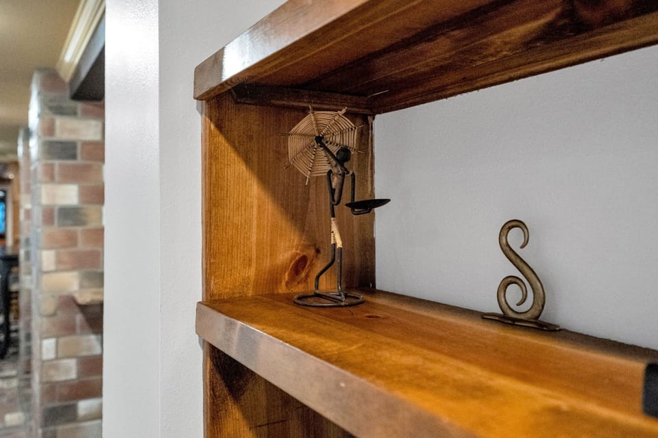 Artfully curated shelf with local decor touches—a subtle nod to the soulful creativity of New Orleans.