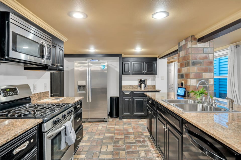 Cook like home with a full suite of stainless appliances, gas range, granite countertops, and deep sink.