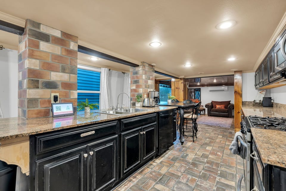 Full kitchen with cozy lounge area
Cook in style with granite countertops, full-size appliances, and a bar that opens to the living space.