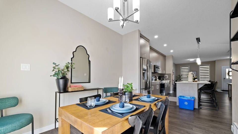 Dinner with flair! Enjoy meals at this stylish table, surrounded by comfortable chairs, a decorative mirror, and tasteful décor. Ready for a feast?