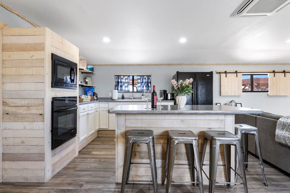 Farmhouse-style kitchen with rustic wood accents, modern appliances, and a spacious island perfect for casual dining.