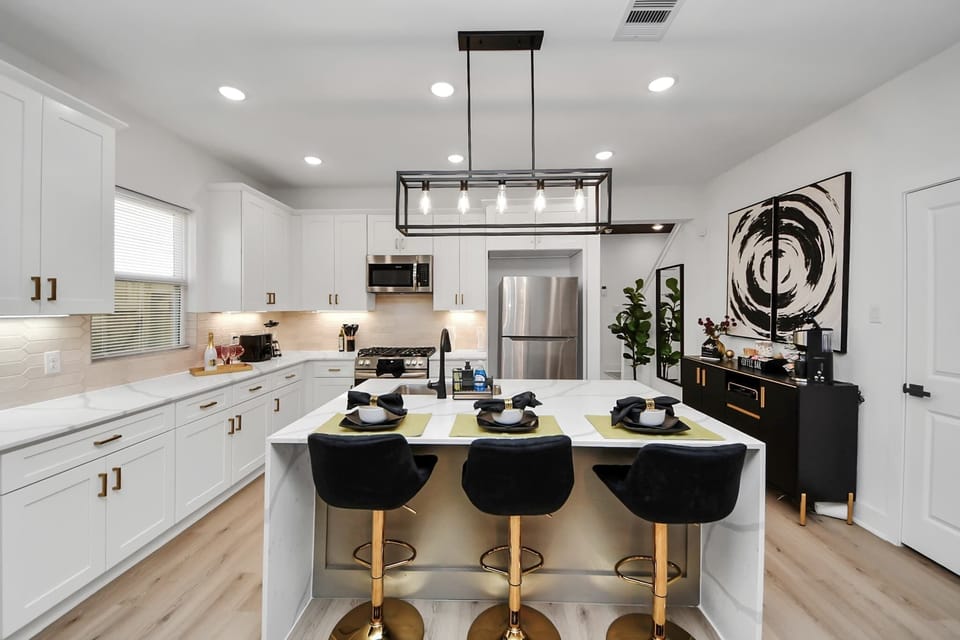 A modern kitchen outfitted with stainless steel appliances, quartz countertops, and everything you need to cook like a pro.