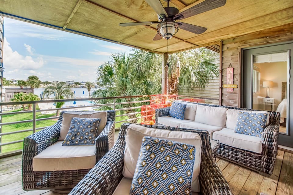 Covered balcony with wicker furniture and Intracoastal views at Needle Rush Poin