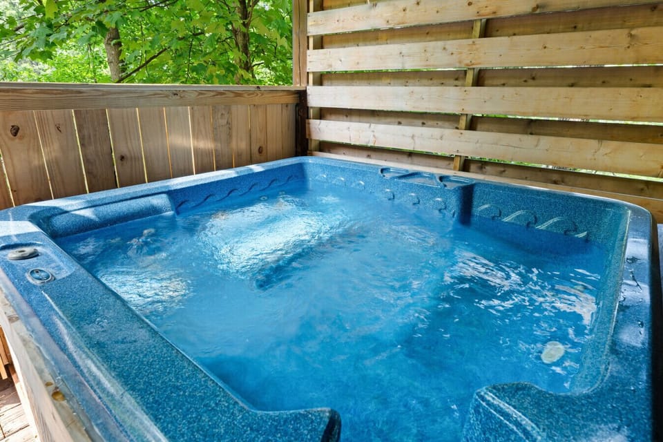 Tucked in its own cozy corner of the porch, this hot tub offers the perfect blend of privacy and outdoor serenity.
