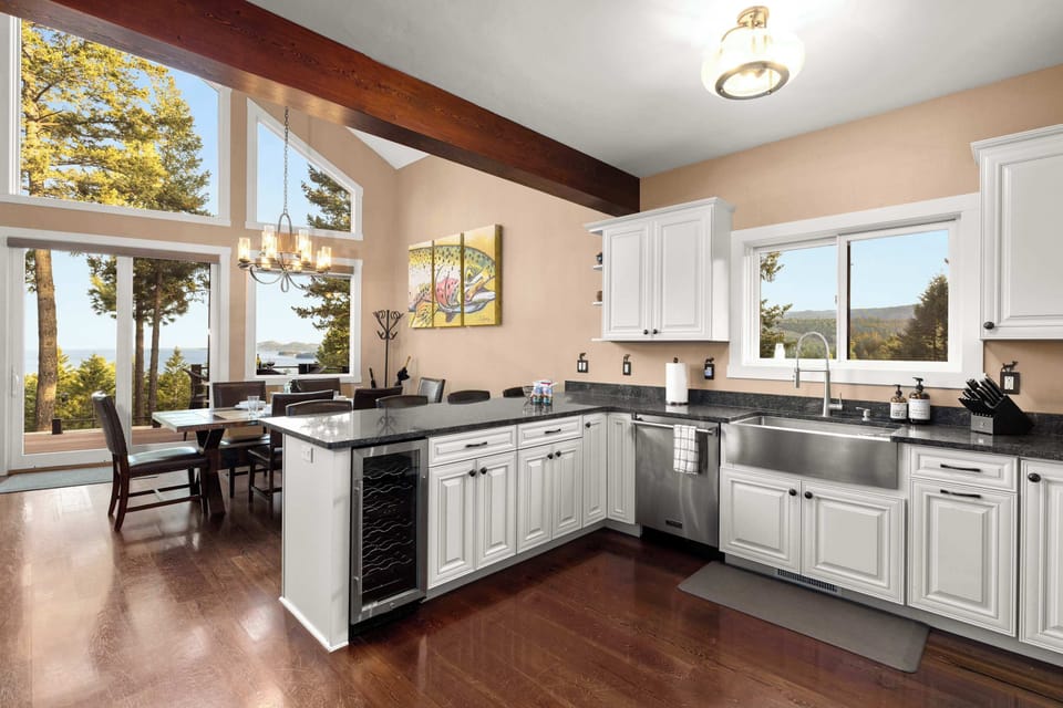 Enjoy an open-concept kitchen and dining area with lake views, high-end finishes, and plenty of space to cook, gather, and entertain.