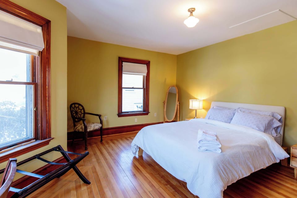 The master bedroom is bright and sunny (with room darkening shades provided for sleeping in late)