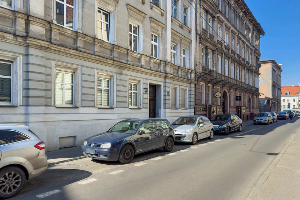 The townhouse facade with large windows and decorative details highlights the area’s historic charm.