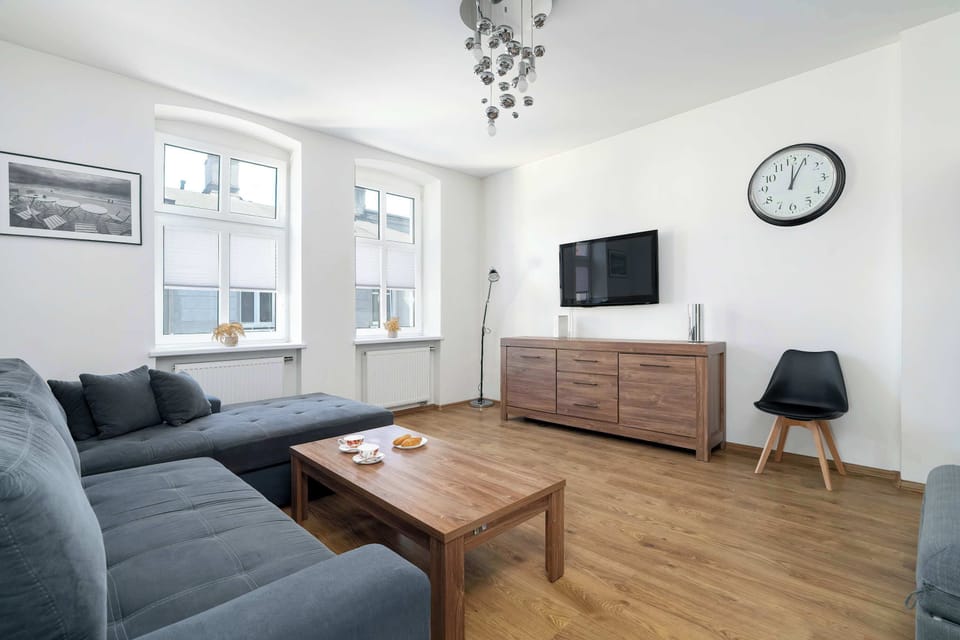 A bright living space with large windows and a soft corner sofa is perfect for spending time together.
