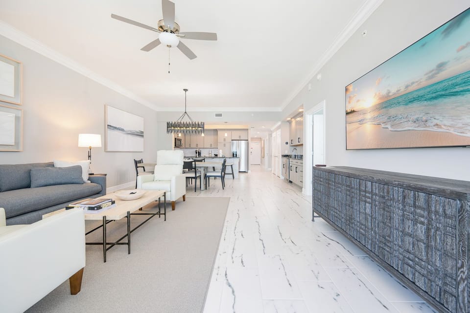 Unwind in this elegant living space featuring stylish seating, a large TV, and a dining space for memorable meals