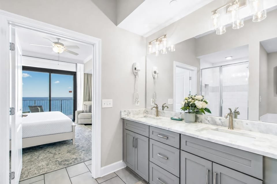 Experience relaxation in the master suite featuring dual sinks, elegant fixtures, relaxing tub, and a large shower