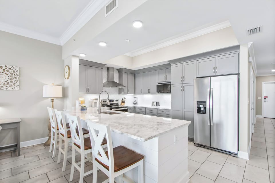 Gather around the spacious kitchen with stylish seating, perfect for family meals and socializing